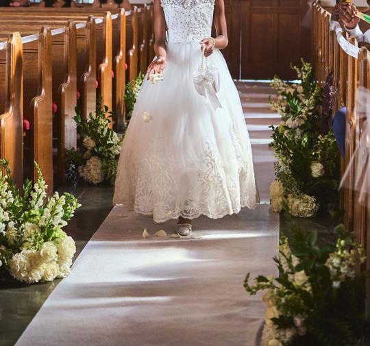 Graceful Moments: The Flower Girl Amidst the Church’s Elegance