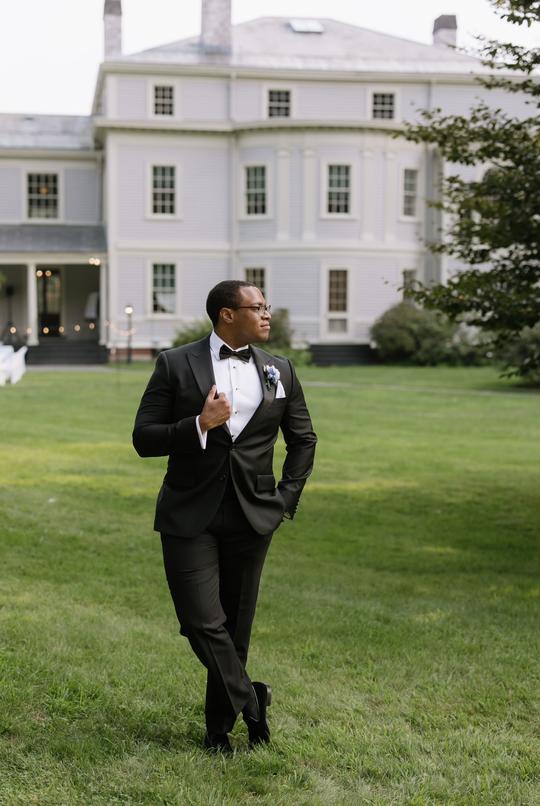 Standing Proud: The Groom and the Estate’s Majestic Backdrop